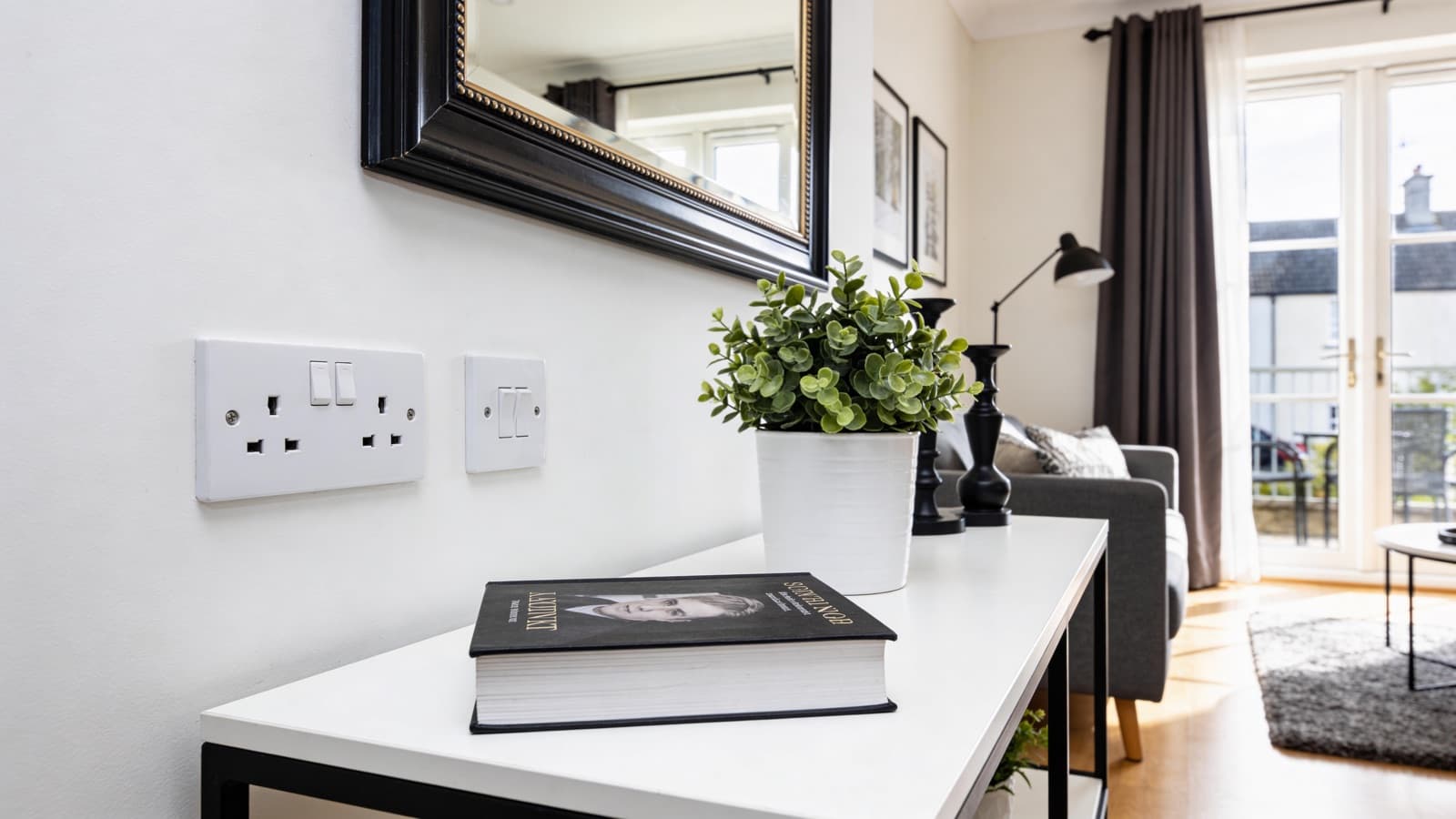 A freshly renovated bright Irish living room with new white sockets and switches on clean painted walls after a rewire